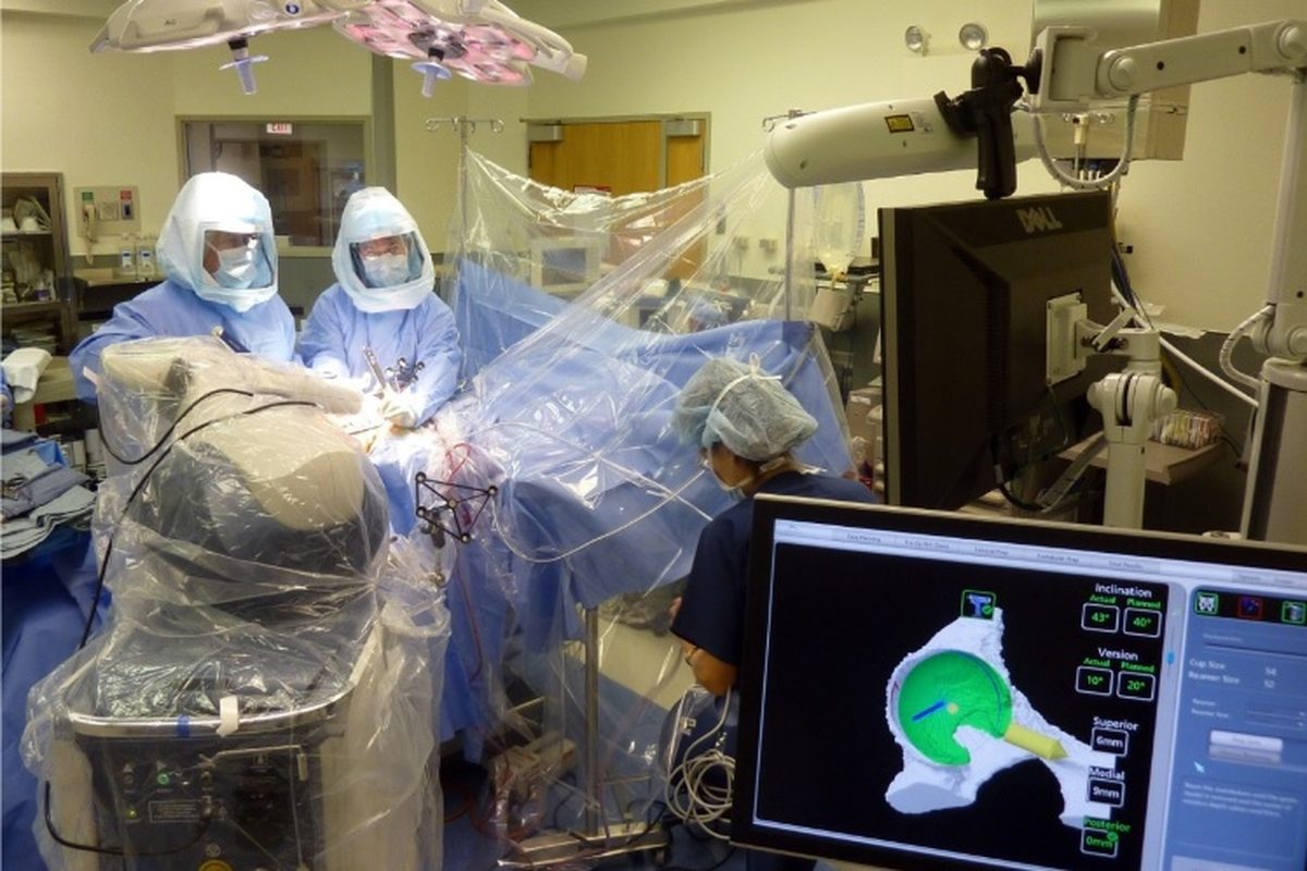 Operating room photograph published by the practice for robotic-arm assisted hip replacement.